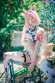 A woman in a cow costume sitting on a chair.