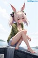 A girl with bunny ears sitting on a wall by the water.