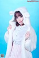 A woman in a white sheep costume posing for a picture.